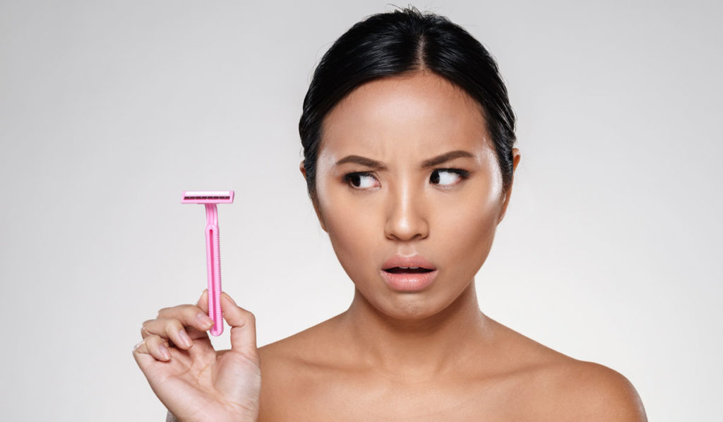 Woman looking at disposable razor