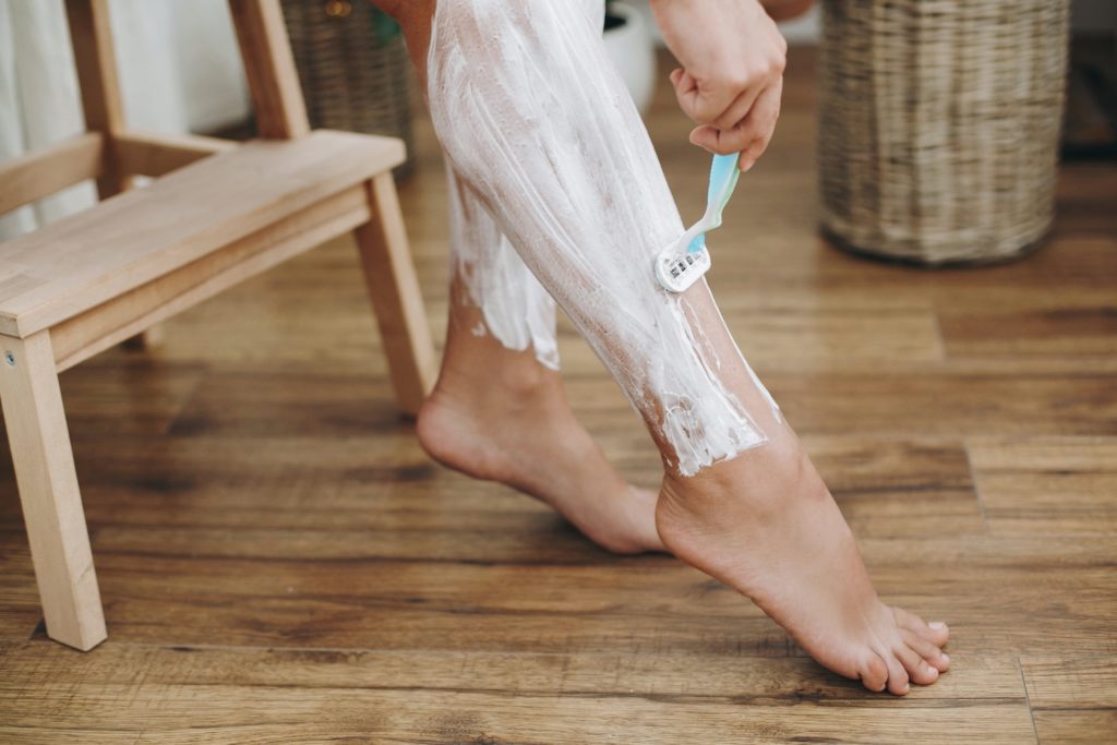 a person shaving their legs