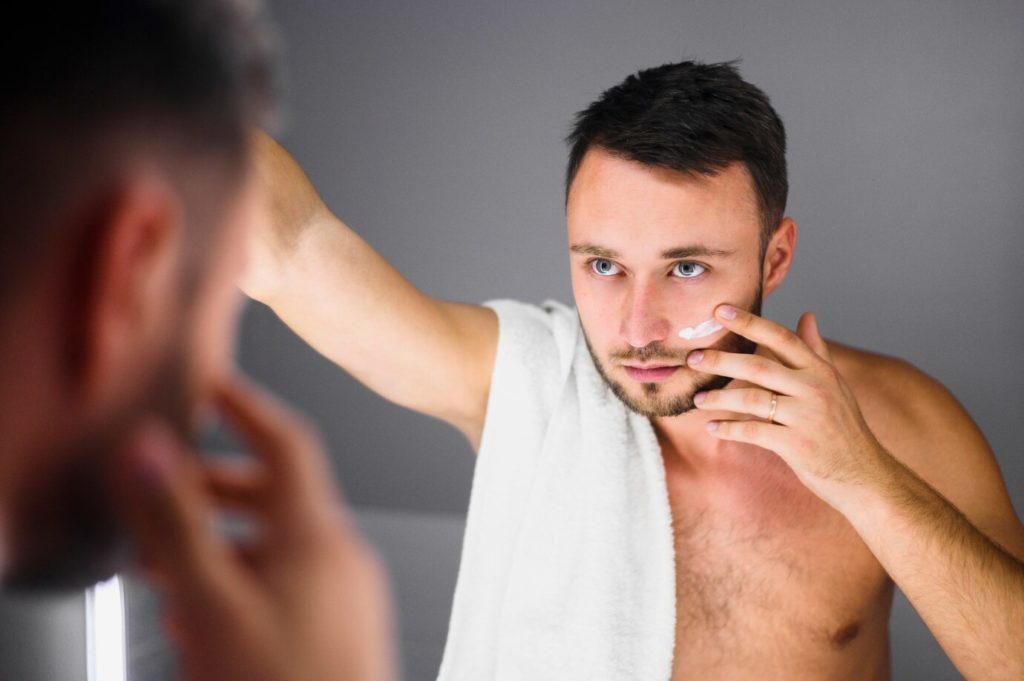 a man looking at himself in the mirror