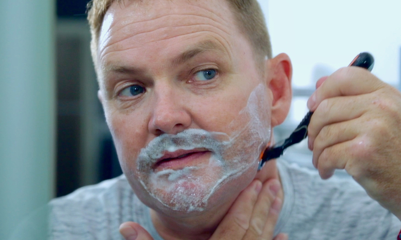 a man shaving his face