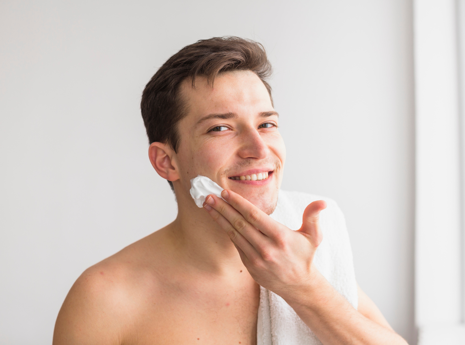 man putting moisturiser