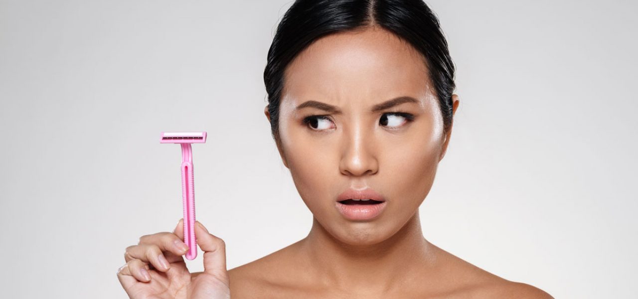 Woman looking at disposable razor